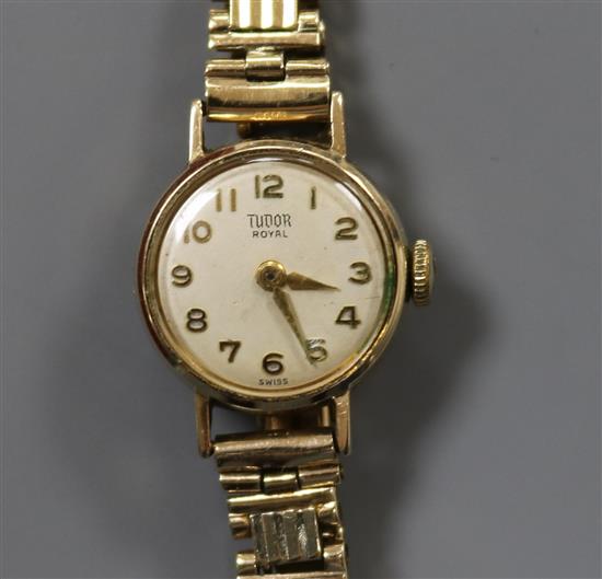 A ladys' 9ct gold-cased Tudor Royal wristwatch on 9ct brick-link bracelet.